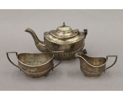 A silver composite bachelor's tea set. The teapot 10.5 cm high. 12.6 troy ounces.