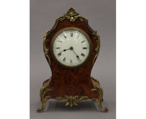 A 19th century French burr walnut mantle clock. 25 cm high.