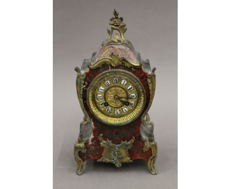 A 19th century Boulle mantle clock. 30 cm high.