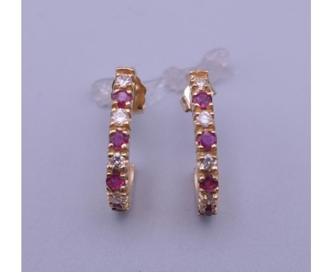 A pair of 14 K gold ruby and diamond ear studs.