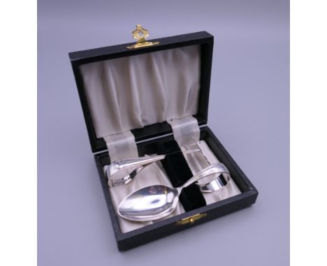 A boxed set of silver baby's cutlery (spoon and food pusher), hallmarked for Birmingham 1947.