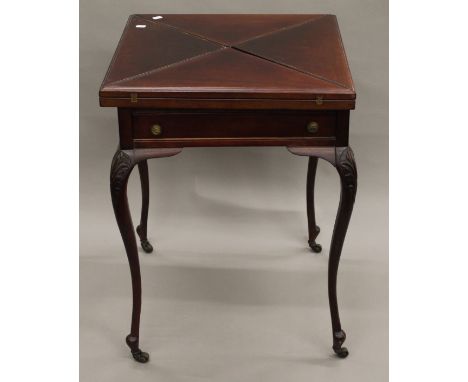 A Victorian mahogany envelope card table. 56 cm square.