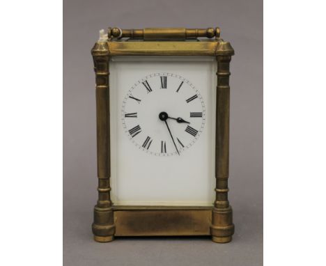 A Victorian gilded brass and enamelled dial eight-day carriage clock, with key. 16.5 cm high.