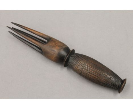 A tribal carved wooden fork. 30.5 cm long.
