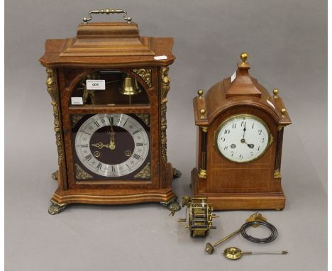An Edwardian inlaid mahogany mantle clock and another. The former 34 cm high.