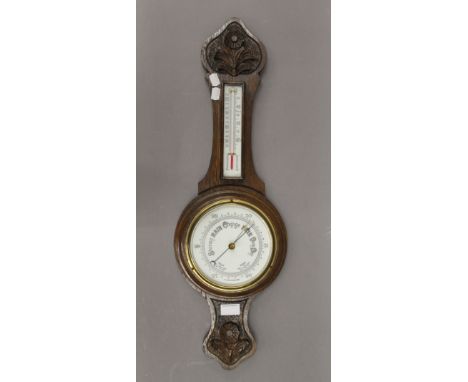 An early 20th century oak barometer. 70 cm high.