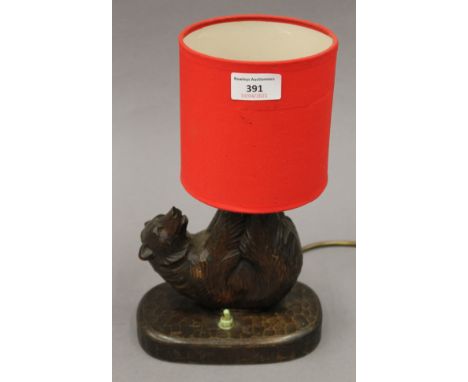 A carved Blackforest bear lamp. 28.5 cm high including shade.