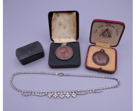 A Winston Churchill medallion, another medallion, a snuff box and a costume jewellery necklace.