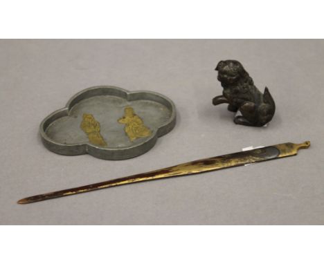 A 19th century gilded bronze Japanese hair ornament, a finely worked Chinese bronze scroll weight in the form of a dog-of-fo 