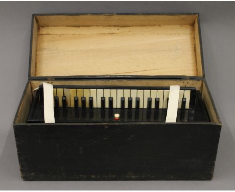A 19th century accordion Harmoniflute by Busson Paris , boxed. The box 52.5 cm wide.