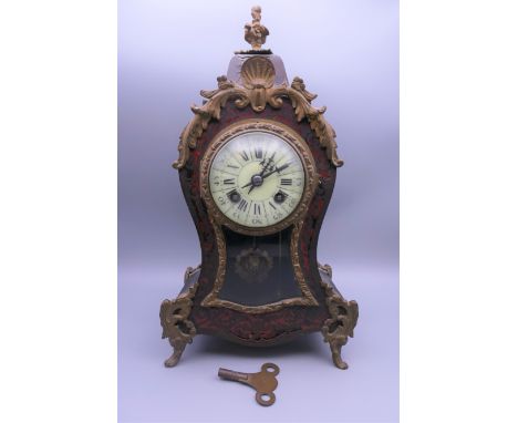 A 19th century Boulle mantle clock. 34 cm high.