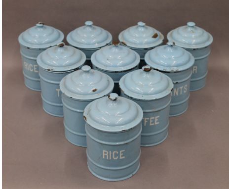 A set of vintage enamel kitchen tins. Approximately 20 cm high.