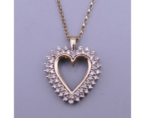 A 10 K gold multi diamond pendant, on a 9 ct gold chain. 