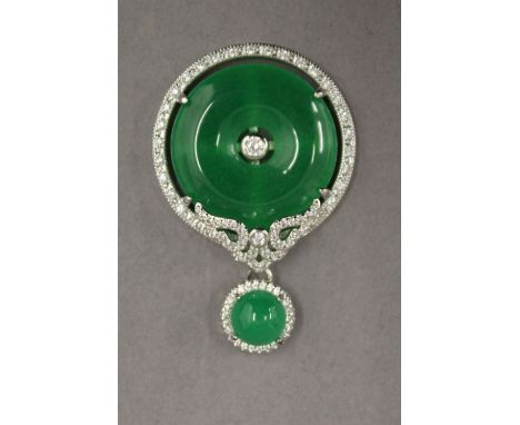A circular jade pendant. 4.5 cm high.