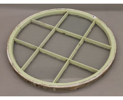 A vintage glazed circular window panel. 80 cm diameter.
