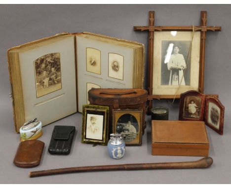 A box of various items, including photograph album, swagger stick, etc.