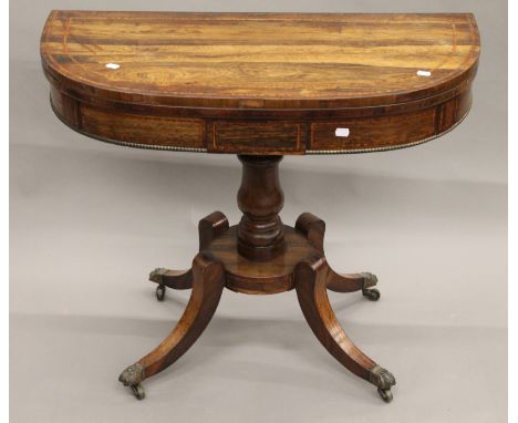 A Regency inlaid rosewood demi lune card table. 90.5 cm wide.