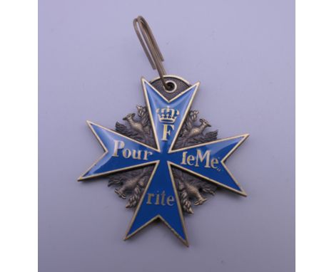 A Continental enamel decorated brass medallion. 5.5 cm high.
