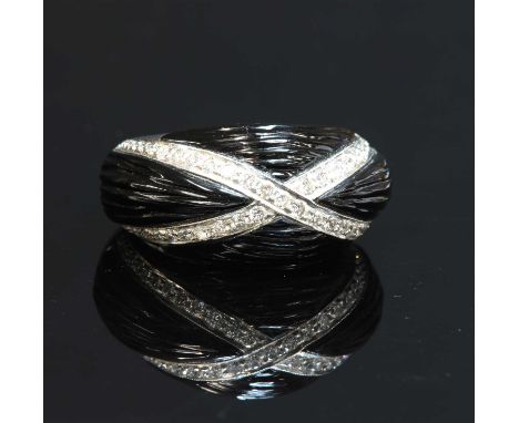 An 18ct white gold onyx and diamond bombé ring, with two rows of brilliant cut diamonds, milligrain set in a crossover to the