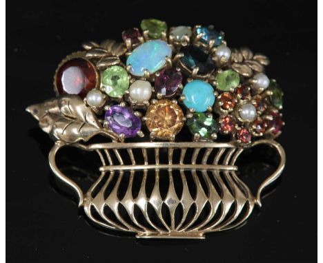 A gold gemstone giardinetti brooch, c.1950, with a selection of assorted gemstones to include opal, blue zircon, peridot, ame