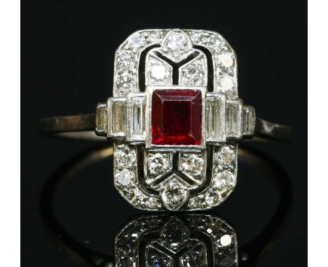 An Art Deco ruby and diamond plaque ring, with a rectangular step cut ruby, rub set to the centre. A rectangular, cut cornere