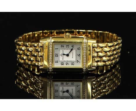 A ladies' 18ct gold diamond set Jaeger-LeCoultre Reverso quartz bracelet watch, model 261.1.08, c.1999. Rectangular silvered 