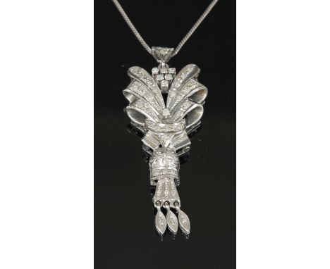 A diamond set spray pendant, with a triangular cluster of eight cut diamonds, four claw set to the top, to radiating ribbons 