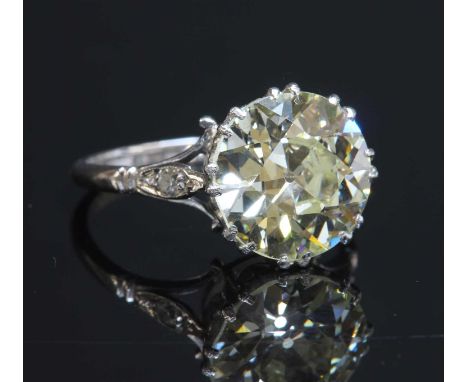 A single stone diamond ring, with diamond set shoulders. A brilliant cut diamond, c.1930, estimated as approximately 4.57ct, 