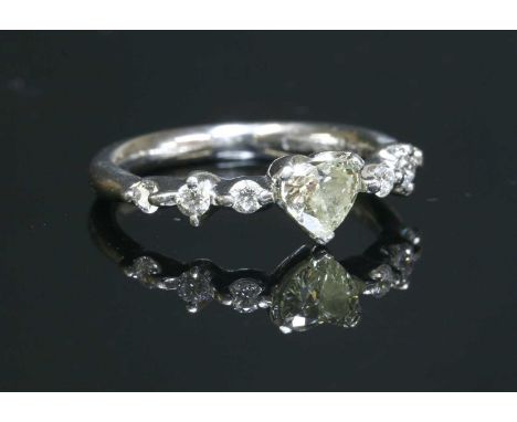 A platinum single stone diamond ring, with diamond set shoulders with a heart cut diamond, with stated weight of 0.567, claw 