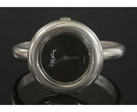 A ladies' sterling silver mechanical bangle watch by Roy King, c.1975, with a circular case, 31mm diameter. A black dial with