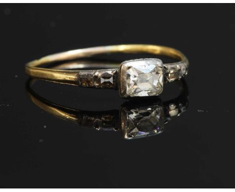 A Georgian single stone diamond ring, with pairs of diamond set shoulders. A rectangular transitional cushion cut diamond, in