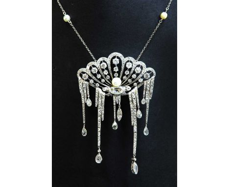 A cased French platinum, pearl and diamond waterfall pendant/brooch, c.1920, attributed to Maingourd. The open clamshell cent