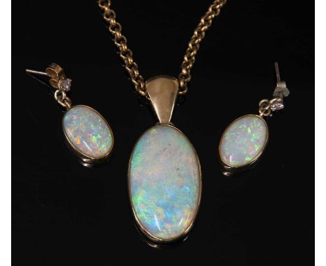 A single stone gold opal pendant and chain, the pendant composed of an oval cabochon opal, rub set in a plain frame with a la