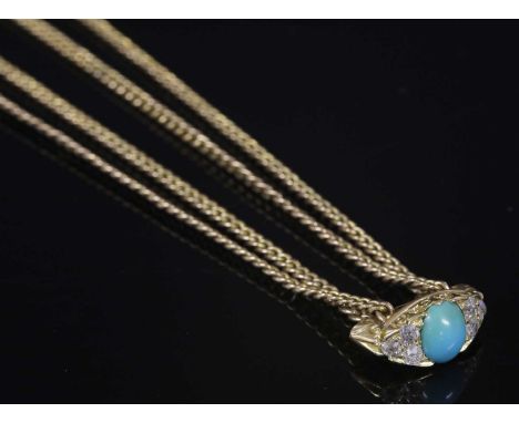 A Victorian gold curb link long chain, with a turquoise and diamond set slide. The carved head-style slide with an oval caboc