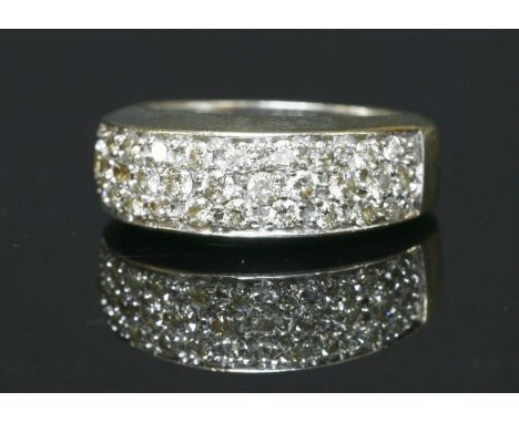 A 9ct gold pavé set diamond tapered band ring, with three rows of brilliant cut diamonds, set to a platinum head. Sheffield 2