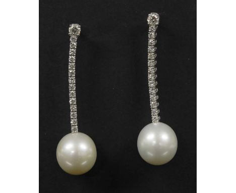 A pair of Continental white gold cultured South Sea pearl and diamond drop earrings, with a brilliant cut diamond, four claw 