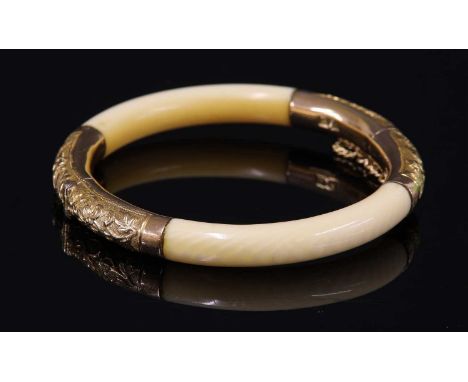 An early 20th century Chinese carved ivory and gold-mounted hinged bangle, possibly by Tuck Chang &amp; Co. Two rolled sectio