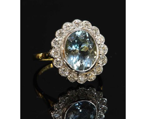 A gold aquamarine and diamond oval cluster ring, with an oval mixed cut aquamarine, with a stated total weight of 3.50ct, mil