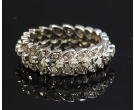 A three row diamond ring, of wreath design, with a central row of raised eight cut diamonds, four claw set with pairs of eigh