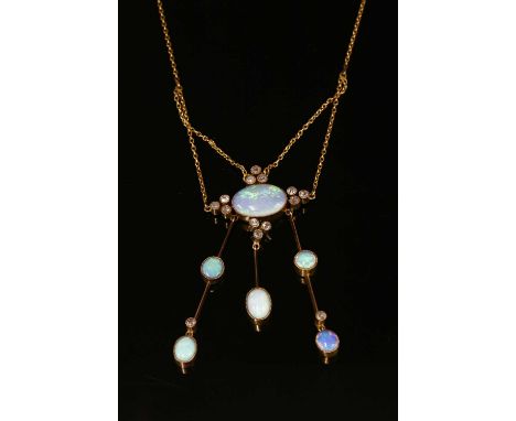 An Edwardian opal and diamond négligée pendant, with an oval cabochon opal, milligrain set to the centre, with trefoil cluste