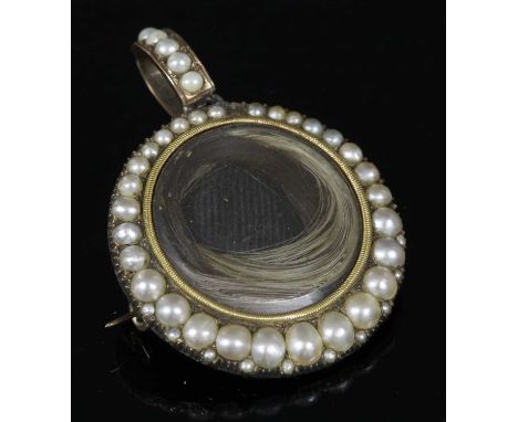 A Georgian cased, gold and split pearl memorial pendant/brooch, c.1810, a circular glazed compartment, with a fine milled edg