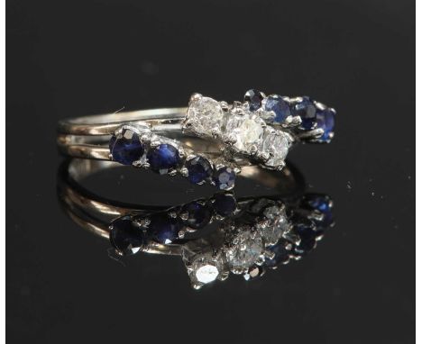 An 18ct white gold three row diamond and sapphire band ring, with three graduated brilliant cut diamonds, claw set diagonally