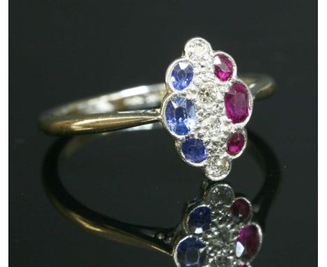 A diamond, sapphire and ruby marquise-shaped cluster ring, c.1915 , with a line of old circular mixed cut diamonds grain set 