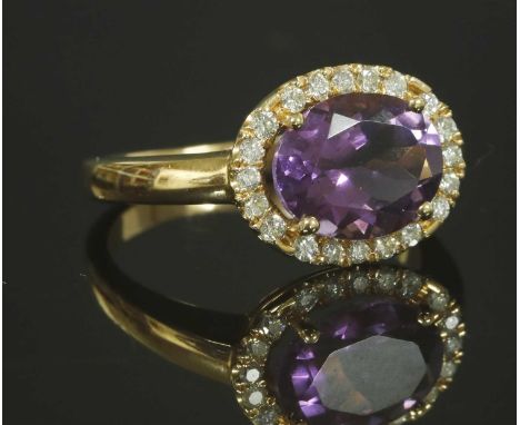 An Italian rose gold amethyst and diamond halo cluster ring, with an oval mixed cut amethyst, with a stated weight of 2.03ct,