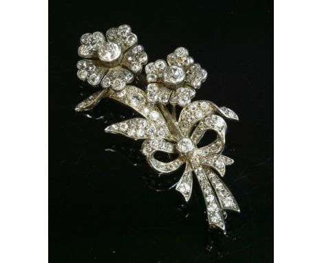 A Victorian diamond set spray brooch, c.1890, with two diamond set flower heads or blooms. Each bloom rub set at the centre w