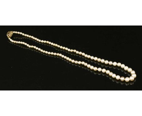 A single row uniform pearl necklace with a diamond set box clasp, c.1910, eighty-nine pearls, 2.7 to 6mm in size, strung knot