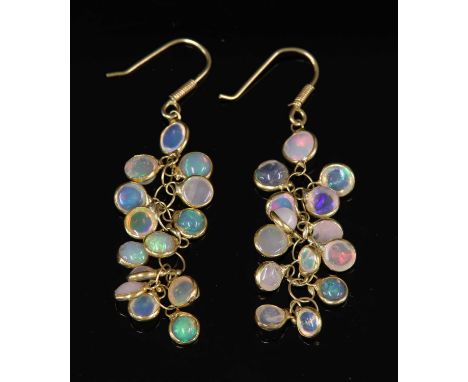 A pair of gold opal drop earrings, with round cabochon opals, spectacle set to a plain frame and all joined by one end to a c