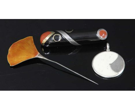 A papier-mâché brooch, by Aya Nakayama, c.1980, of elongated oval domed form with tan section to a black ground, with applied