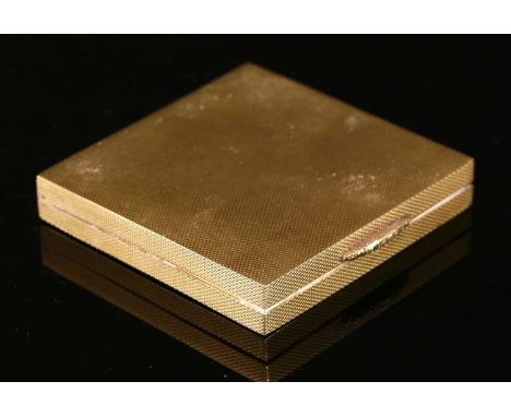 A 9ct gold square flat section hinged powder compact, with engine turned barley decoration, chased floral push piece, and int