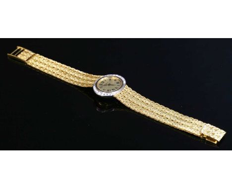 A ladies' 18ct gold diamond set L U Chopard mechanical bracelet watch, c.1970, an oval, landscape textured champagne dial, wi